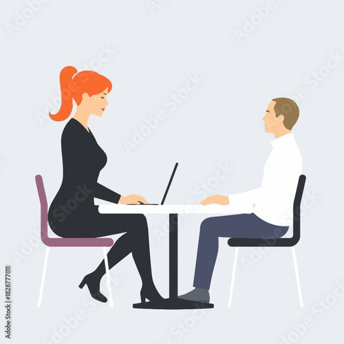 A businesswoman with a laptop conducts a job interview with a male candidate at a table.
