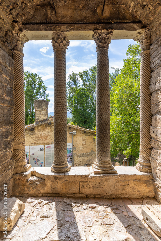 Fototapeta premium Ancient columns framing view of Tempietto sul Clitunno, Umbria