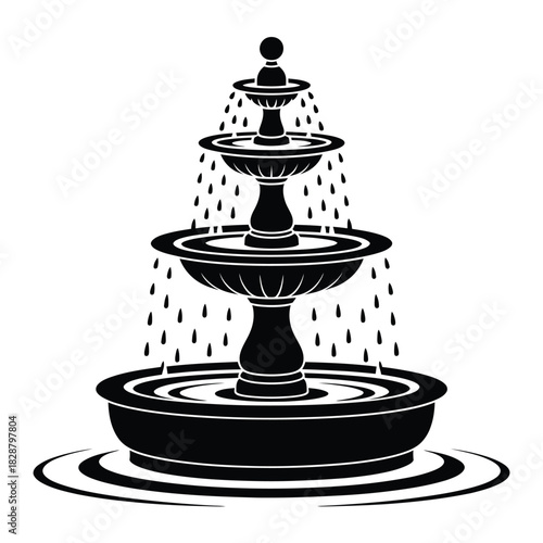 Classic tiered water fountain with cascading water in silhouette