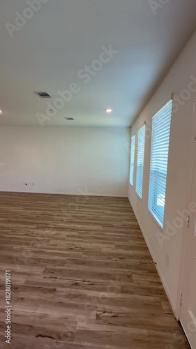 Empty House Interior Open Concept Living Room and Kitchen with Wood Flooring.  