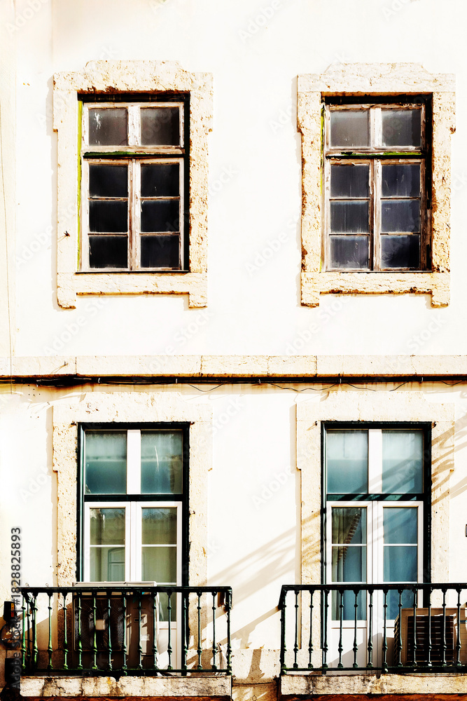Fototapeta premium Typical old buildings in Lisbon's lower town, with their windows with balconies, lanterns, and decorative tiles. Lisbon, Portugal, 2023