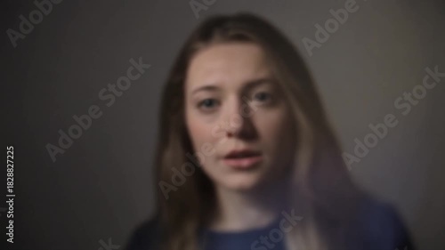 person appears out of focus in front of the camera, creating a sense of confusion