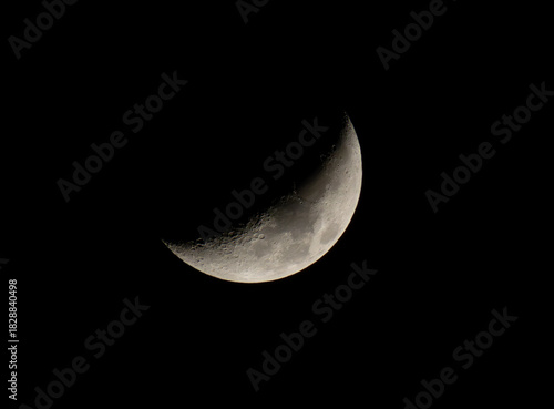 A detailed crescent moon glowing against a dark night sky, ideal for educational materials, astronomy articles, science blogs, space-themed designs, digital wallpapers, and creative visual projects.