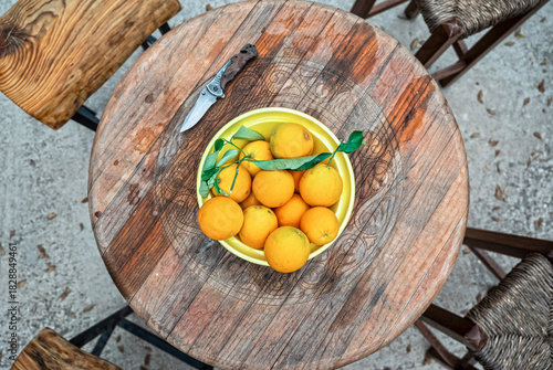 top view of a wooden table with freshly picked organic oranges ready to serve