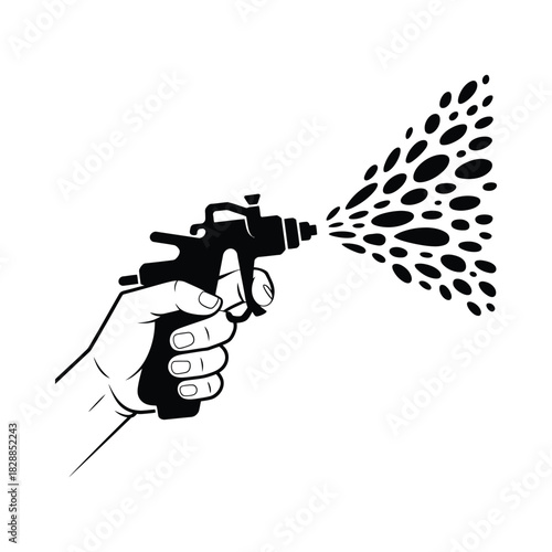 Hand holding spray gun dispensing black dots