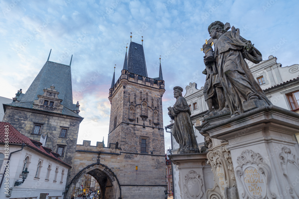 Fototapeta premium Religious statue of Vitus with Mala Strana Bridge Tower, Charles Bridge, Czech Republic