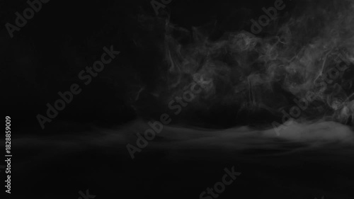 Wispy white smoke swirling on a dark background mist