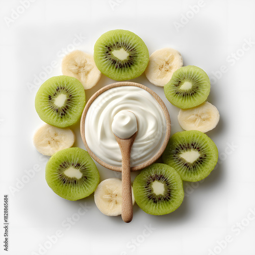 Healthy yogurt with kiwi and banana slices in wooden bowl top view isolated on white background