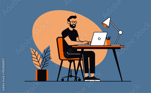 Bearded man working on laptop at desk in home office with plant and lamp, showcasing modern remote work lifestyle.