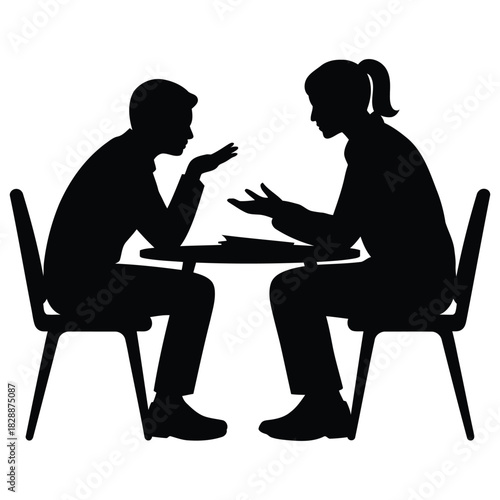Silhouette of two person sitting opposite each other at a table having a serious discussion or meeting