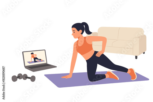 Young woman doing home workout following online fitness class on a laptop