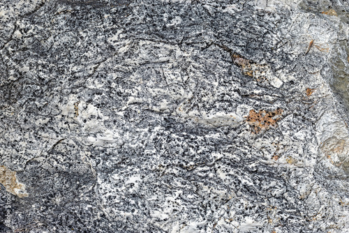Rough gray stone texture with natural pores and detailed patterns, offering a raw and organic look, ideal for backgrounds, design surfaces, and natural themed projects