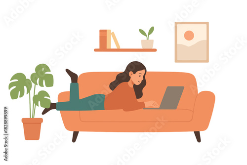 Young woman lying comfortably on an orange sofa working remotely on a laptop in a cozy home setting