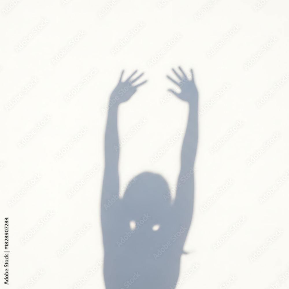 Obraz premium Shadow of a person reaching up with hands outstretched.