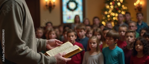 A teacher reading the bible to a group of children in church. Sunday school lesson during the Christmas holiday. Religious education and faith community