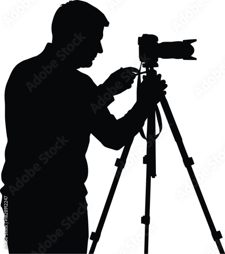 Silhouette of a photographer adjusting a tripod