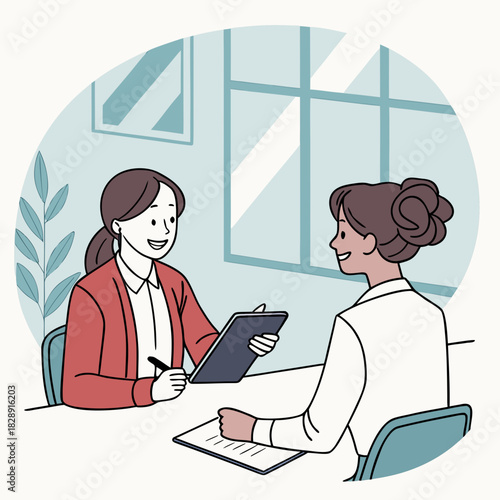 Two women in a professional setting discussing and taking notes during a meeting or interview