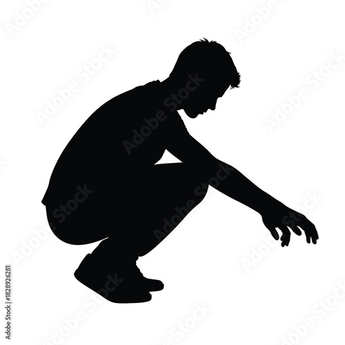 A silhouette of a boy crouching and reaching downward thoughtfully
