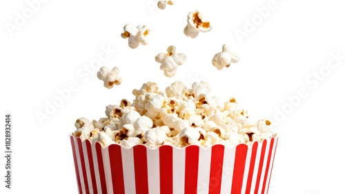 Popcorn scattered in the air over a red and white striped bucket ready for a movie night at home