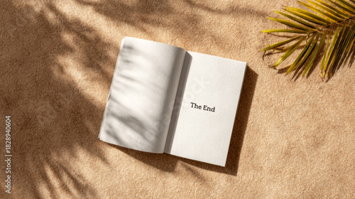 Open book showing the end on the final page, symbolizing conclusion, finality, and new beginnings on a sandy beach