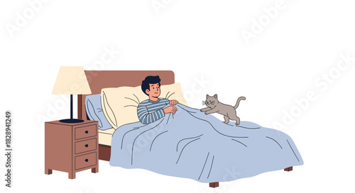 A man is waking up in bed as his playful grey cat jumps on the duvet in the early morning.
