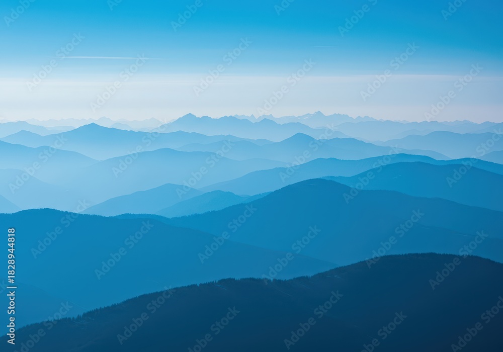 Fototapeta premium Scenic mountain range featuring hazy blue peaks stretching toward the horizon beneath a brilliant, cloudless sky ,day ,sky ,view