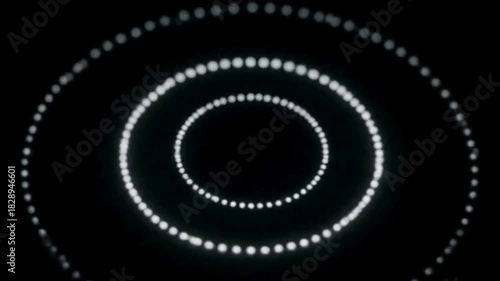 Hypnotic glowing circles of light create a mesmerizing tunnel effect on a dark background.