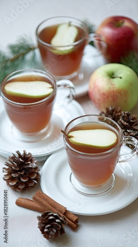 a festive apple cocktail, garnished with cinnamon sticks and slices of an asian pear on the rim