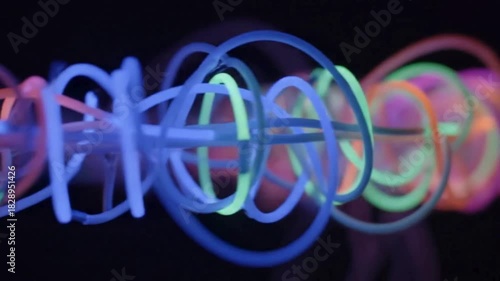 Abstract glowing neon lines creating a futuristic, dynamic visual effect against a dark background