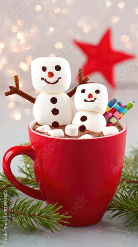 a red mug of hot chocolate with two marshmallows on top in the shape of snowmen