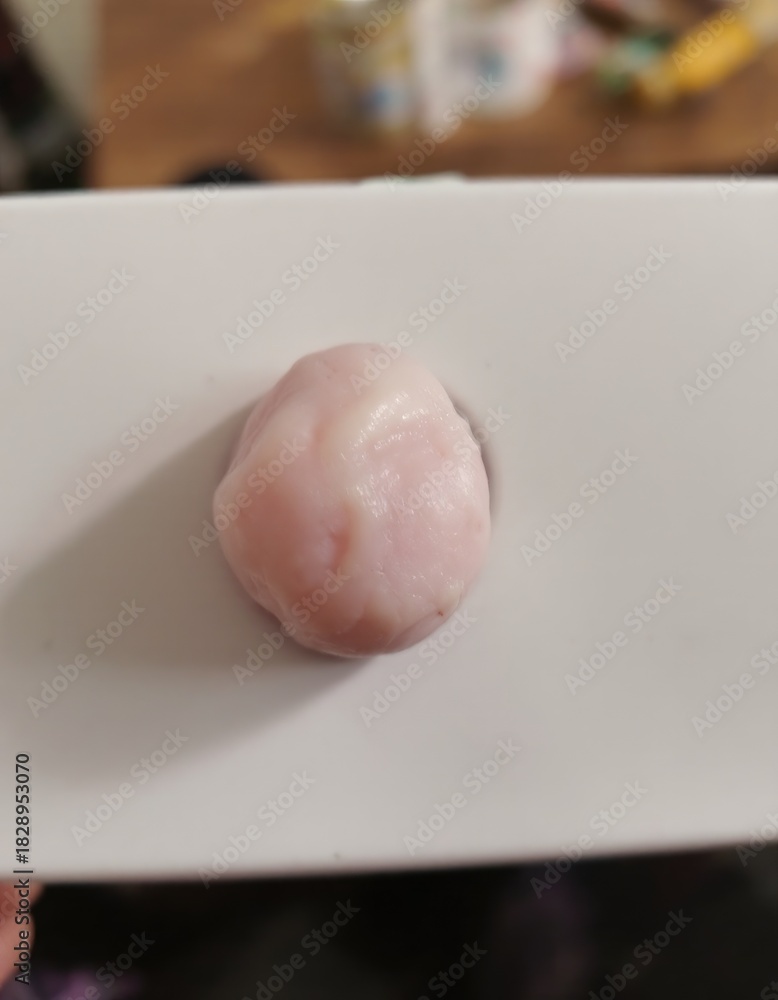 Fototapeta premium Pink, round, gummy food item on white tray