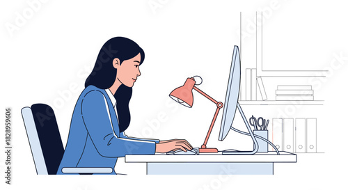 Side view of a focused young business woman in a suit working or typing on a computer at her desk in the office.