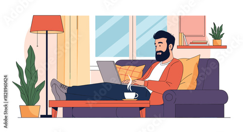 A bearded man is relaxing on a sofa and working from home on his laptop with a cup of coffee in a cozy room.