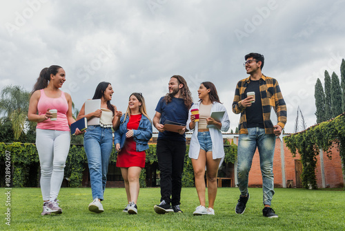 group of Latino university students walking together outdoors in public park. young hispanic people woman and men in Mexico Latin America