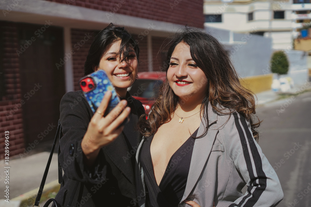Fototapeta premium Two smiling adult women friends taking selfie