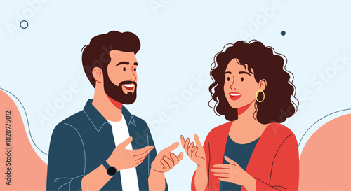 A friendly man and woman are engaged in an animated conversation gesturing with their hands and smiling in a pleasant discussion.