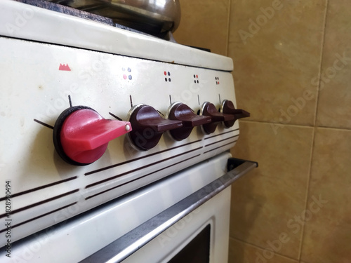 Kitchen stove with controls and knobs in a home setting