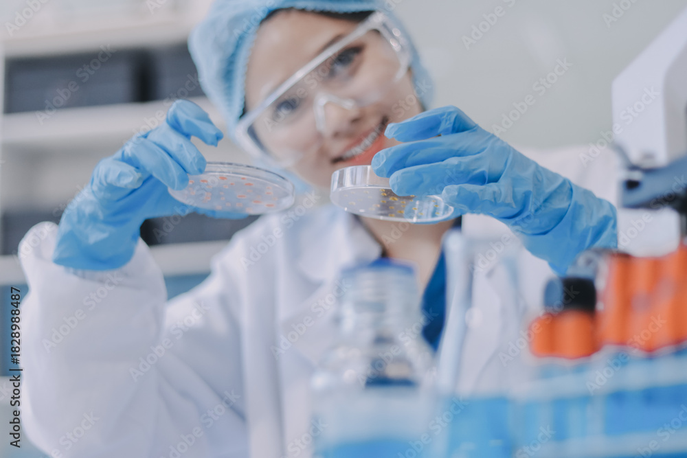 Fototapeta premium Portrait, science and happy woman on laptop in lab to research chemistry, test or innovation. Microscope, scientist and face of medical doctor in goggles for microbiology, healthcare or pharma study
