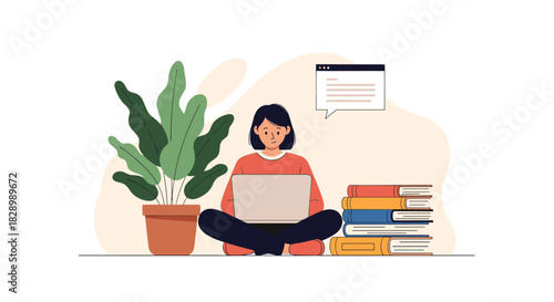 A young woman studying or working from home sitting cross-legged on the floor with her laptop a stack of books and a houseplant.