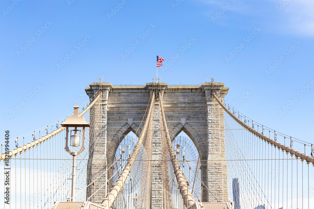 Fototapeta premium The pedestrian section of the Brooklyn Bridge in New York City is empty of people during the day.