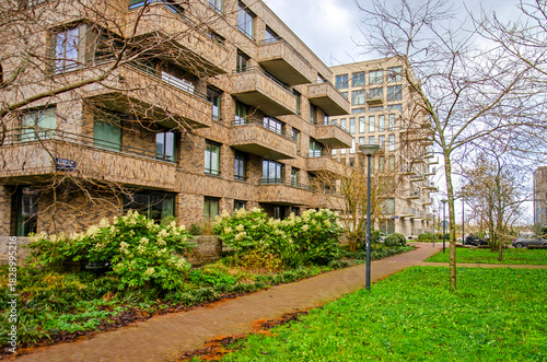 Amsterdam, The Netherlands, November 25, 2025: modern brick apartment buildings with green surroundings on Zeeburgereiland neighbourhood