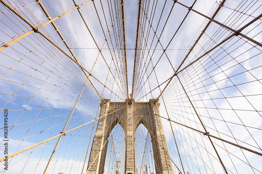 Fototapeta premium The pedestrian section of the Brooklyn Bridge in New York City is empty of people during the day.