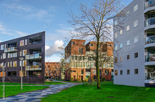 Amsterdam, The Netherlands, November 25, 2025: modern apartment blocks with meandering footpaths in green environments in Funenpark neighbourhood