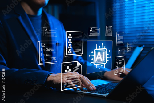 Businessman using AI-powered software on laptop for automated resume screening and candidate selection. Concept of artificial intelligence in HR tech, AI recruitment analytics and digital hiring.