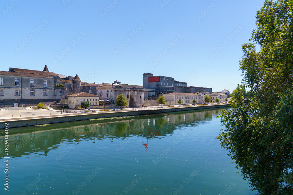 Fototapeta premium The embankment of the Charente River in the city of Cognac France Several buildings of the famous Cognac house are visible along the embankment