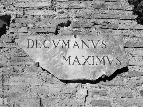 Ostia Antica, Italy - November 23, 2025, the plaque of the decumanus maximus, the main street with an east-west orientation in Roman urban planning, in the archaeological excavations of Ostia Antica.