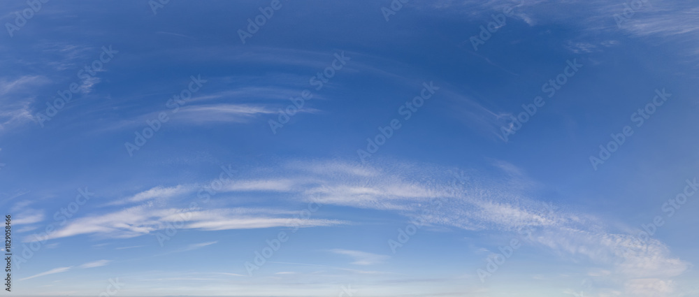 Fototapeta premium Bright Blue Sky With Wispy Clouds Over Calm Horizon – Cloudscape Background