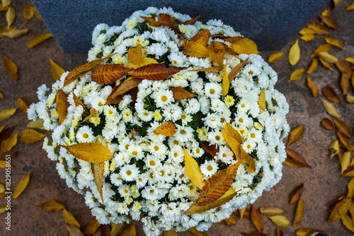 Autumn Leaves Resting on White Chrysanthemum Bouque