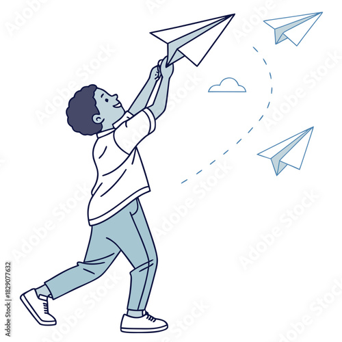 Boy releasing paper airplanes with playful joy