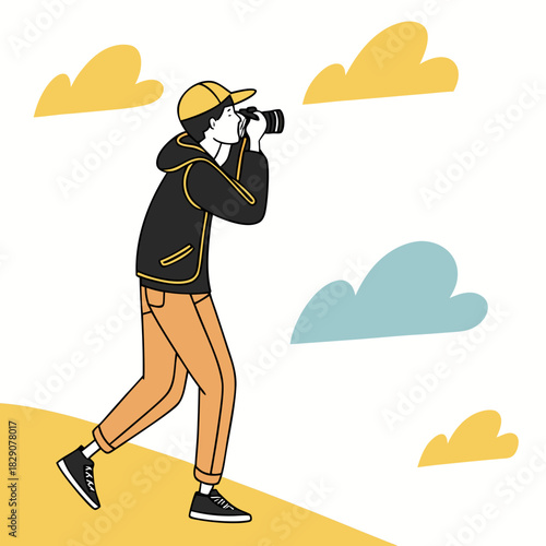 Teenage boy taking photos outdoors with a camera